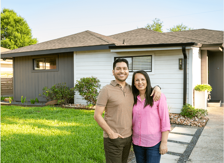 Two people standing by suburban house